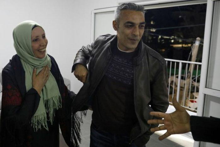 Iman al-Khatib, an Arab Israeli newly elected to Israel's parliament, speaks to supporters in the northern Israeli town of Kafr Kanna, with her brother at her side