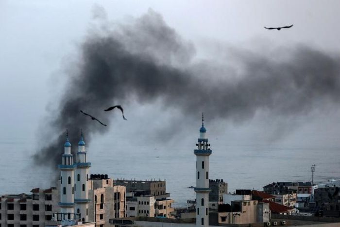 Smoke rises over Gaza City as Israel carries out a second day of air and missile strikes in response to barrages of rocket fire following its targeted killing of a top militant