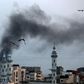 Smoke rises over Gaza City as Israel carries out a second day of air and missile strikes in response to barrages of rocket fire following its targeted killing of a top militant