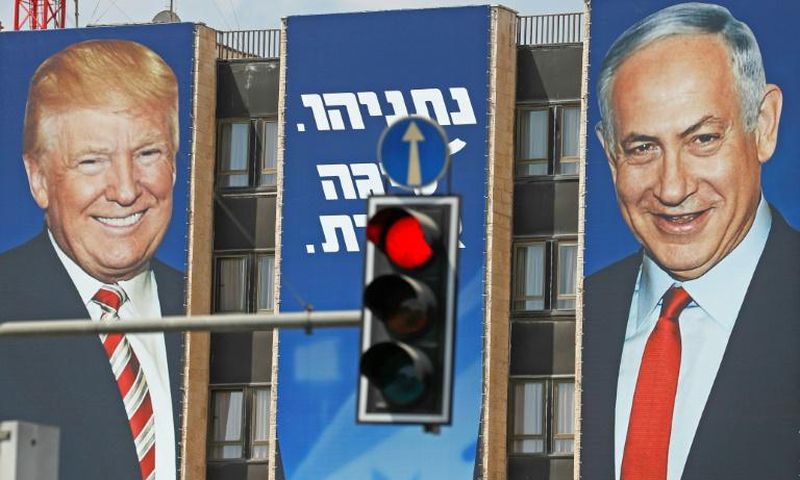 An Israeli election banner pictured in September 2019 bears the portraits of US President Donald Trump (L) and Prime Minister Benjamin Netanyahu hanging on a building facade in Jerusalem