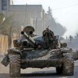 A rebel tank patrols the streets of Saraqeb, reduced to a ghost town abandoned by its residents after weeks of fighting