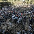Hundreds had been sitting on a tiered wooden structure for hours when it collapsed