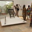 Visitors contemplate artefacts recently returned to Benin and on show at Cotonou's "Petite Musée de la Recade