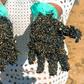 A volunteer shows his crude-encrusted gloves at Praia de Busca Vida beach in Bahia state during a cleanup operation on November 3