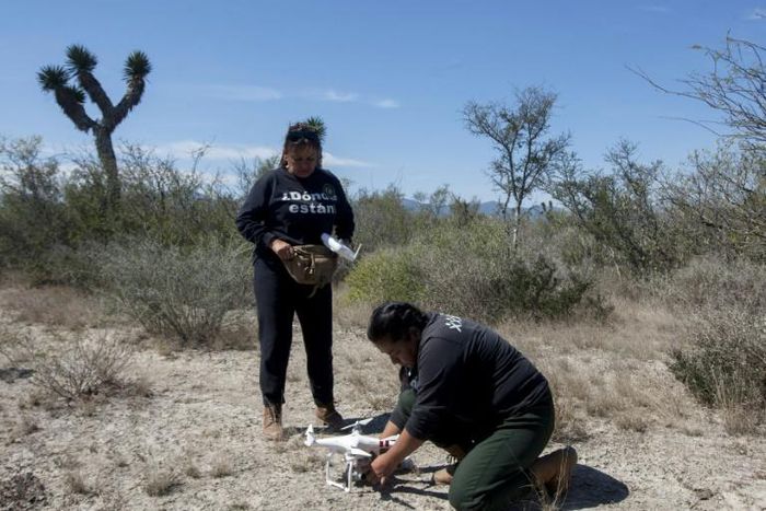 Leticia Hidalgo (L) and Angelica Orozco, members of United Forces for our Disappeared in Nuevo Leon, prepare a drone to look for human remains in Salinas Victoria Feburary 24, 2020