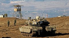 Israeli troops equipped with armoured vehicles survey neighbouring Syria from the Golan Heights, a strategic plateau Israel seized from Syria in the Six-Day War of 1967