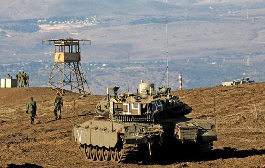 Israeli troops equipped with armoured vehicles survey neighbouring Syria from the Golan Heights, a strategic plateau Israel seized from Syria in the Six-Day War of 1967