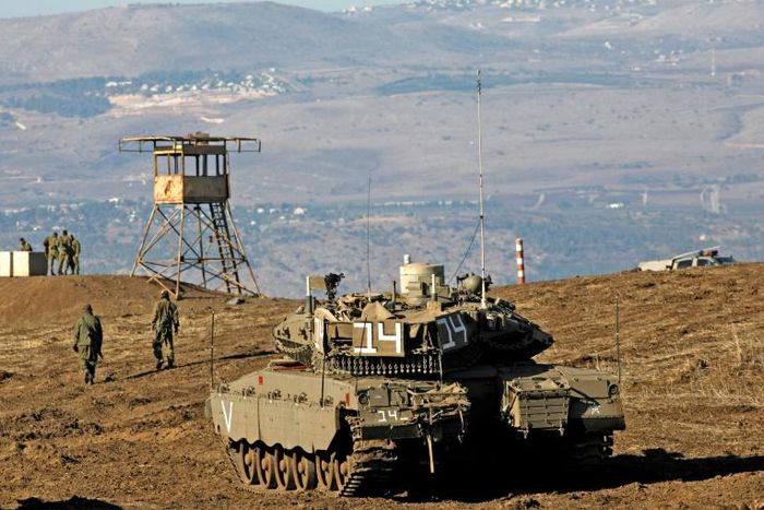 Israeli troops equipped with armoured vehicles survey neighbouring Syria from the Golan Heights, a strategic plateau Israel seized from Syria in the Six-Day War of 1967