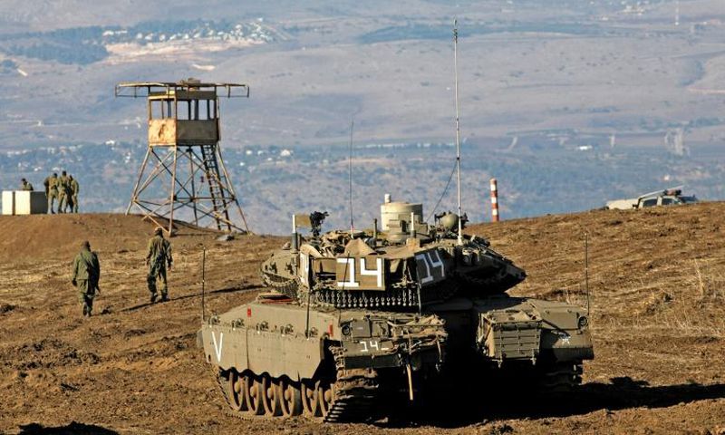 Israeli troops equipped with armoured vehicles survey neighbouring Syria from the Golan Heights, a strategic plateau Israel seized from Syria in the Six-Day War of 1967