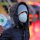 An Iranian street vendor sells protective masks in the capital Tehran