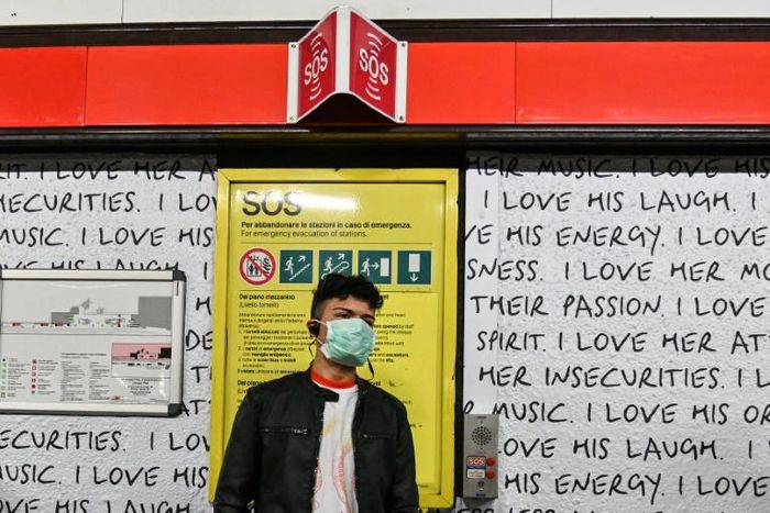 A man wearing a respiratory mask in the Milan subway.