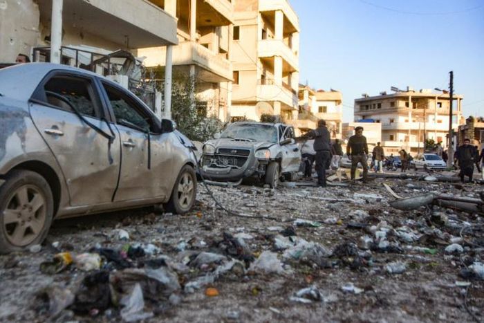 Damaged cars line a street following an air strike in Maarat Misrin on Tuesday
