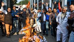 Activists protest against the rape and murder of a 27-year-old woman in India. Police later shod dead the four detained suspects as they re-enacted the crime