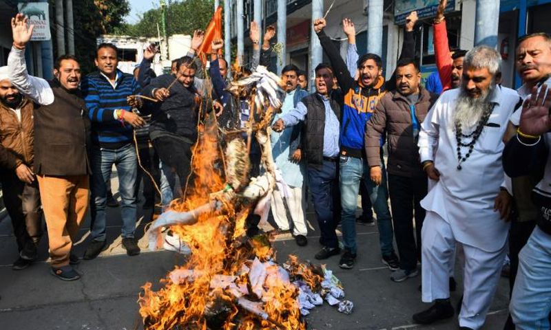 Activists protest against the rape and murder of a 27-year-old woman in India. Police later shod dead the four detained suspects as they re-enacted the crime