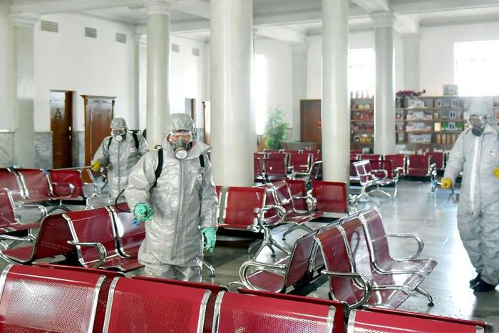 This undated picture released from North Korea's official Korean Central News Agency (KCNA) on February 15, 2020 shows people in protective suits spraying disinfectant at an undisclosed location in North Korea, amid concerns of the COVID-19 outbreak