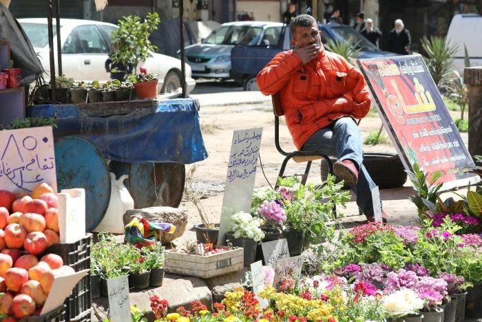 Syrian residents of Damascus like florist Abdelqader Qasem are still struggling to rebuild their lives as the conflict that has devastated the country enters its 10th year