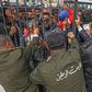 Tunisians angered by a coronavirus lockdown gather outside a government office on the outskirts of the capital