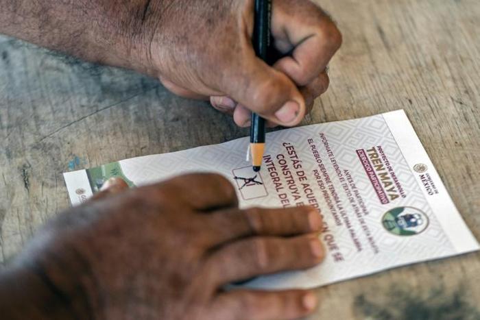 A citizen marks his ballot during a referendum on building a "Maya Train", in Felipe Carrillo Puerto, Champoton, Campeche state, Mexico, on December 15, 2019