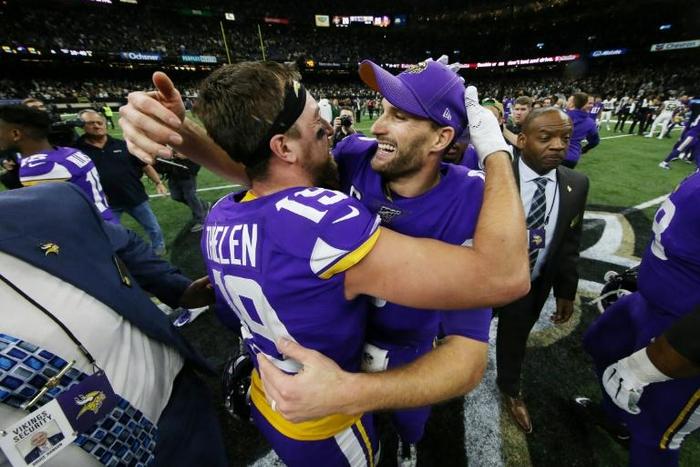 Minnesota Vikings quarterback Kirk Cousins, right, celebrates with Adam Thielen, left, after the Vikings defeated the New Orleans Saints 26-20 in the NFL playoffs Sunday