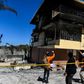 Firefighters speak to a local judge (C) as they point at the Orphanage of the Church of Bible Understanding where a fire broke out the previous night in the Kenscoff area outside of Port-au-Prince February 14, 2020