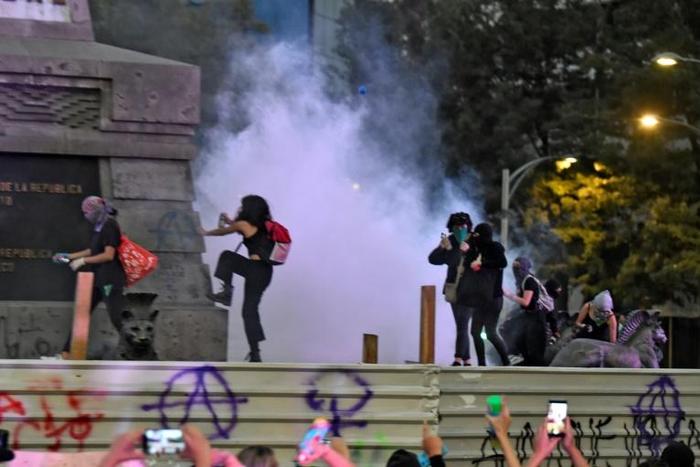 Activists vandalise a monument as they protest on International Day for the Elimination of Violence Against Women, in Mexico City, on November 25, 2019
