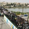 Large numbers of Iraqi Shiites defy curfews imposed to stem the spread of the coronavirus to commemorate a revered imam
