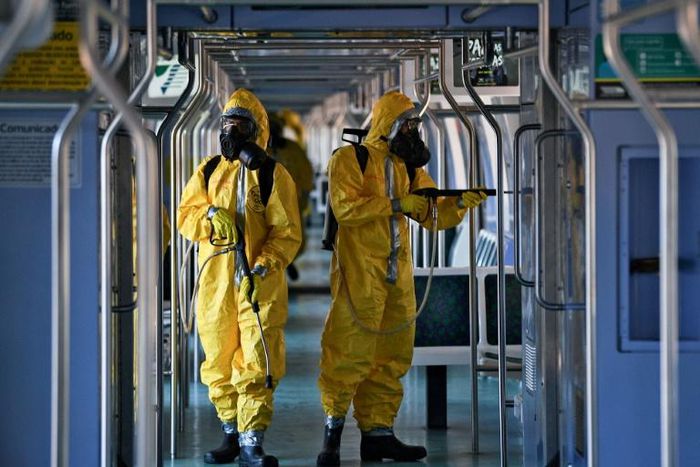 Brazilian soldiers disinfect a train wagon at the central station in Rio de Janeiro