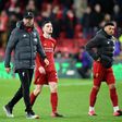 Liverpool's German manager Jurgen Klopp leaves the pitch with Andrew Robertson and Alex Oxlade-Chamberlain