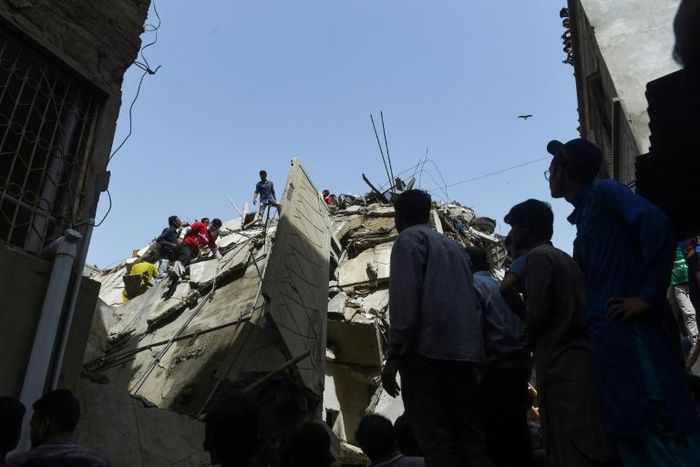 Rescuers search for victims in the rubble of a collapsed residential building in the Pakistani city of Karachi on Thursday