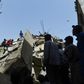 Rescuers search for victims in the rubble of a collapsed residential building in the Pakistani city of Karachi on Thursday