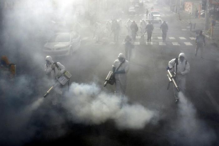 Firefighters disinfect streets in the Iranian capital Tehran in a bid to stem the spread of the coronavirus