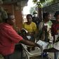 Visitors to a state hospital in Lagos collect facemasks and gloves and have their hands sanitised