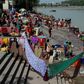 Indians dry their clothes after taking a holy dip in the River Ganges at Rishikesh, where about 700 foreign tourists remain as India's virus lockdown continues