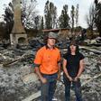 Brother and sisters Jesse and Kiahan Bellchambers stand in front of the charred ruins of their home in Batlow, in Australia's New South Wales state