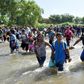 Central American migrants - mostly Hondurans, travelling on caravan to the US- cross the Suichate River, the natural border between Tecum Uman, Guatemala and Ciudad Hidalgo, Mexico, on January 20, 2020