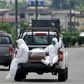 People wearing protective suits accompany a coffin on a truck near Los Ceibos hospital in Guayaquil, Ecuador on April 8, 2020