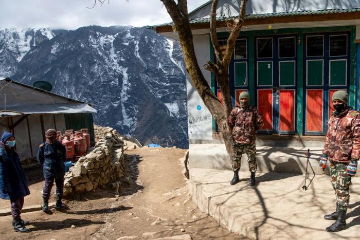 Security personnel stand guard during a nationwide lockdown in Namche Bazar in the Everest region. Thousands of tourists and trekkers are stranded in far-flung areas of Nepal