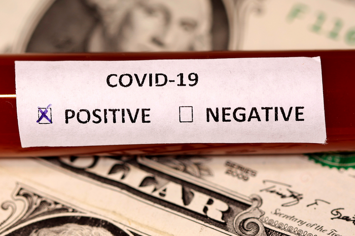 FILE PHOTO: A test tube labelled with the coronavirus is placed on U.S. dollar banknotes, in this illustration taken on March 1, 2020. REUTERS/Dado Ruvic