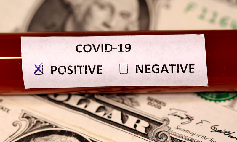 FILE PHOTO: A test tube labelled with the coronavirus is placed on U.S. dollar banknotes, in this illustration taken on March 1, 2020. REUTERS/Dado Ruvic
