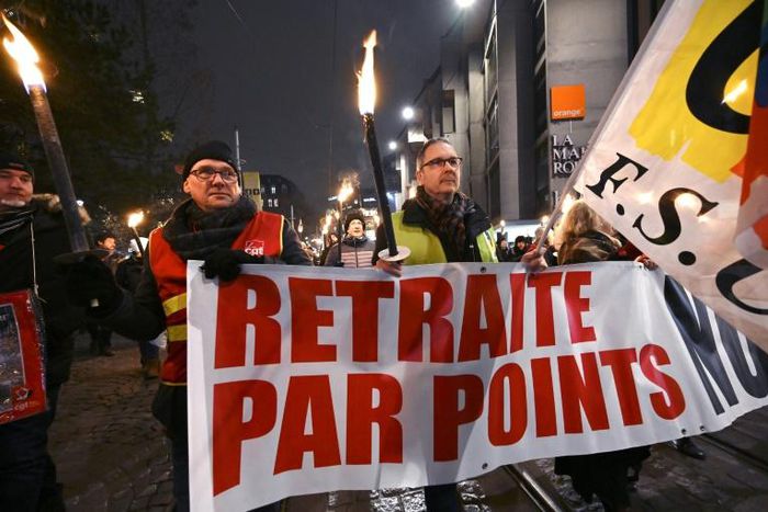 Protesters marched with torches in Strasbourg, eastern France, on Thursday against the French government's pension overhaul.