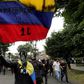 Protestors with their faces covered wave flags during a demonstration against the government of Colombia’s President Ivan Duque in Bogota