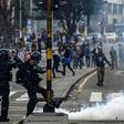 A riot policeman kicks a tear-gas canister during an anti-government protest in Bogota on November 23, 2019