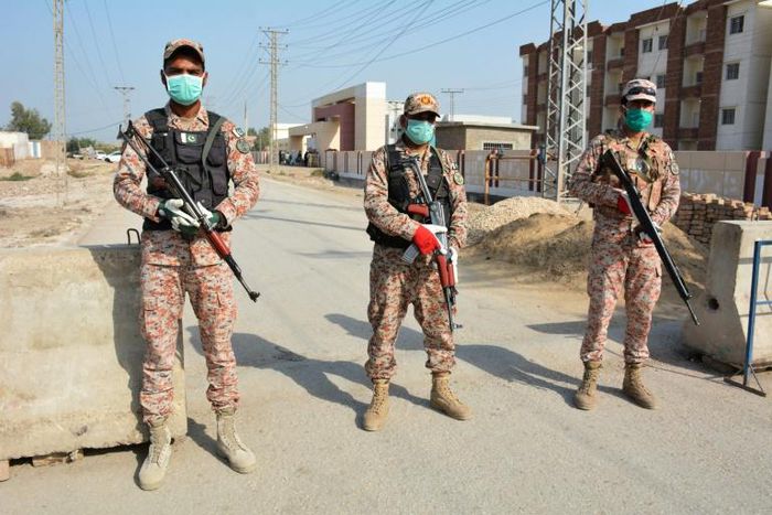Soldiers guard a road leading to the Taftan quarantine facility
