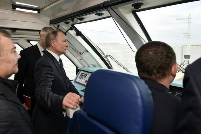 Russian President Vladimir Putin rides a train connecting the Crimea to mainland Russia