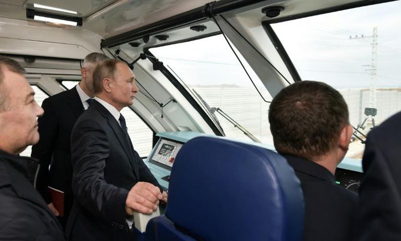 Russian President Vladimir Putin rides a train connecting the Crimea to mainland Russia