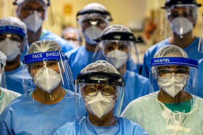 A group of doctors working with patients infected with the novel coronavirus COVID-19 wear face shields at the Intensive Care Unit of the Hospital de Clinicas in Porto Alegre, Brazil
