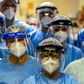 A group of doctors working with patients infected with the novel coronavirus COVID-19 wear face shields at the Intensive Care Unit of the Hospital de Clinicas in Porto Alegre, Brazil