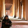 A woman prays in the main mosque in Srinagar after it opened for the first time in nearly five  months