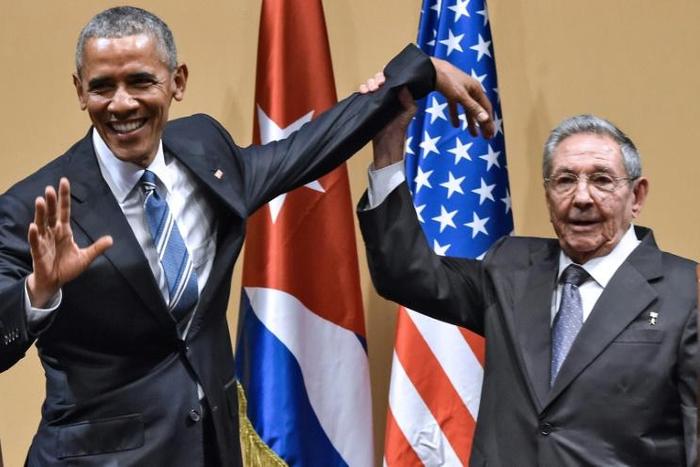 Cuban president Raul Castro raises US president Barack Obama's hand in Havana on March 21, 2016