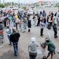 Shoppers stand in a queue as they wait to enter the Jabulani Mall in Soweto